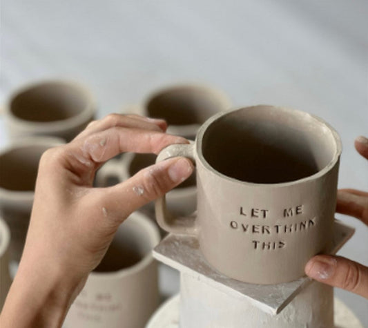 Émaillage à la main d'un mug en céramique à l'atelier Studio Séleste